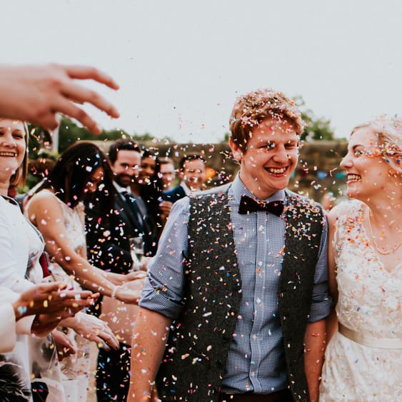 Confetti Moment | Bride in Catherine Deane Gown | Groom in Ben Sherman Suit, Bow Tie & Gingham Shirt | Colourful Barn Reception at Lineham Farm in Leeds | Shutter Go Click Photography