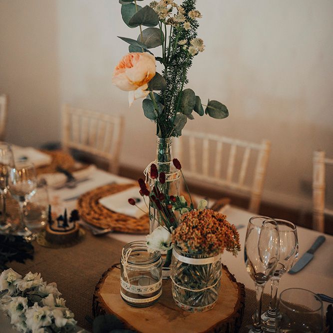 Rustic Centrepiece with Tree Slice & Flower Stems in Bottle & Jam Jars | DIY Woodland Wedding at Two Woods Estate in Sussex | PJ Phillips Photography