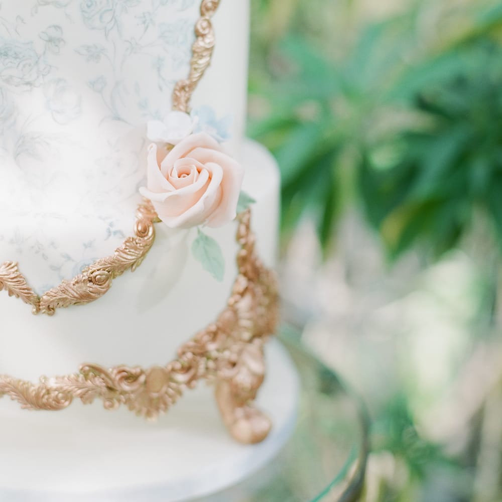 Ornate Wedding Cake With Gold Icing Detail