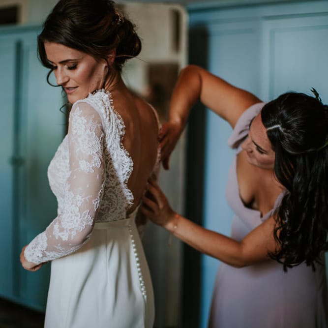 Bride in Long Lace Sleeve Gown from Morgan Davies | Bridesmaid in Reformation Dress | D&A Photography | Ben Walton Films