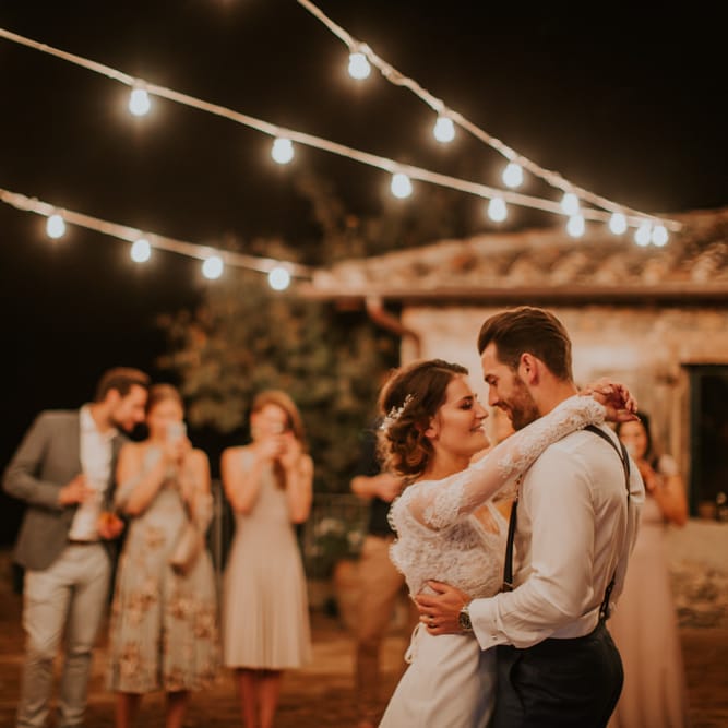 First Dance Under Festoon Lights | Bride in Morgan Davies Gown | Groom in Suit Supply | D&A Photography | Ben Walton Films