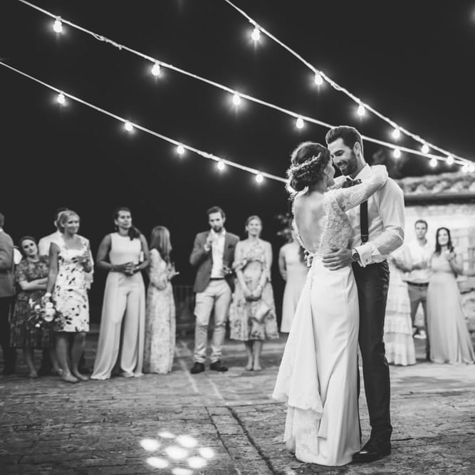 First Dance Under Festoon Lights | Bride in Morgan Davies Gown | Groom in Suit Supply | D&A Photography | Ben Walton Films