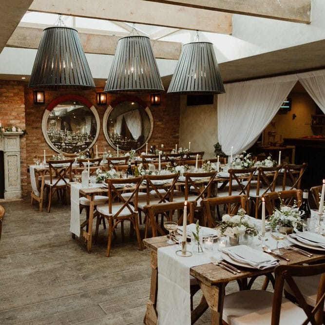 Wooden Trestle Tables With Soft Grey Runners, Taper Candles And White Florals For Wedding Image By The Curries