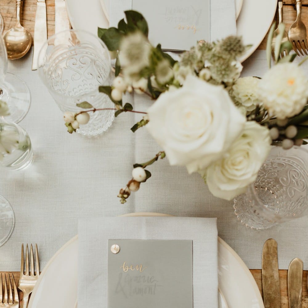 Wooden Trestle Tables With Soft Grey Runners, Taper Candles And White Florals For Wedding Image By The Curries