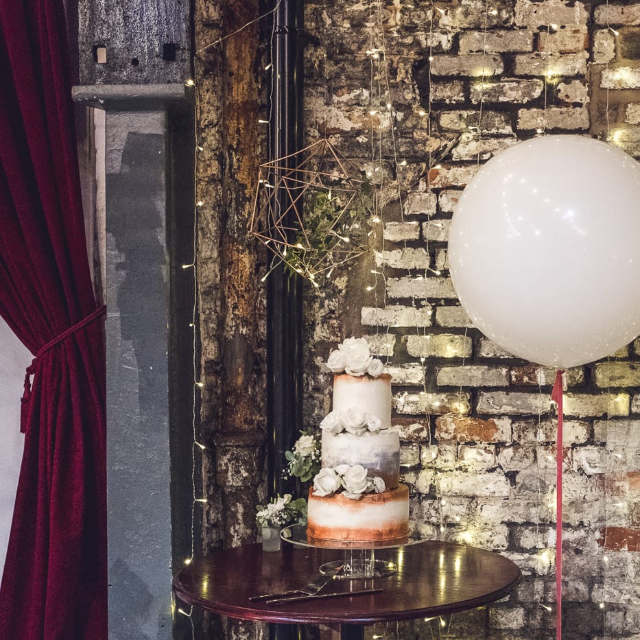 White & Copper Wedding Cake with Giant Balloon | Contemporary City Wedding at People's History Museum & Hope Mill Theatre, Manchester Planned by Alternative Weddings MCR | Babb Photography
