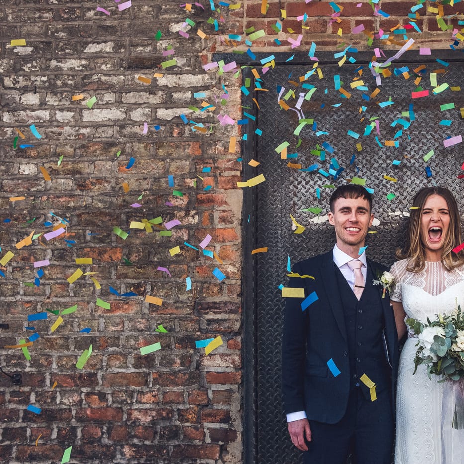 Confetti Moment | Bride in Leonora Watters Gown | Groom in Navy Suit | Contemporary City Wedding at People's History Museum & Hope Mill Theatre, Manchester Planned by Alternative Weddings MCR | Babb Photography