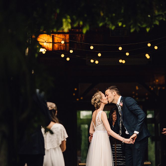 Bride in Catherine Deane Tamsin Wedding Dress & Groom in Paul Smith Suit
