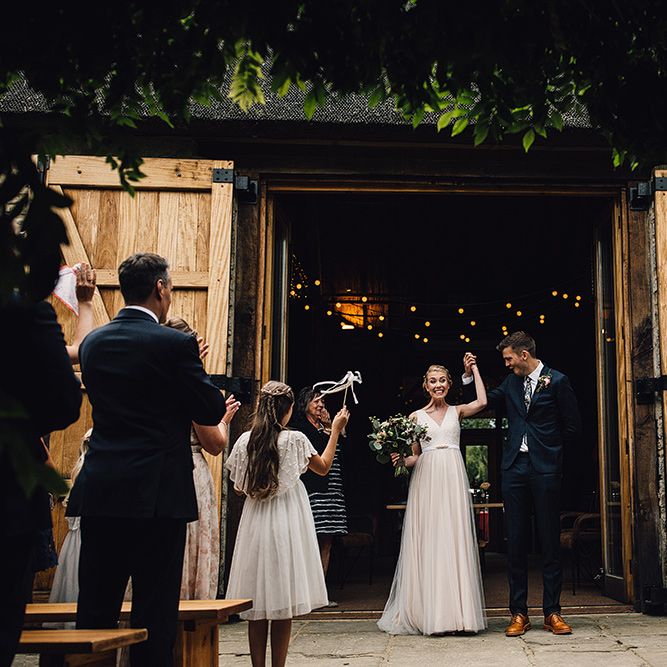 Bride in Catherine Deane Tamsin Wedding Dress & Groom in Paul Smith Suit