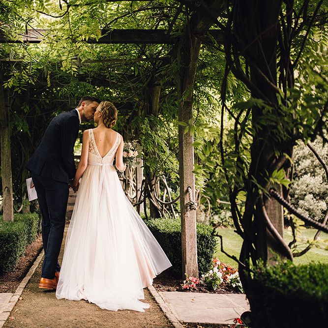 Bride in Catherine Deane Tamsin Wedding Dress & Groom in Paul Smith Suit