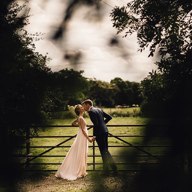 Bride in Catherine Deane Tamsin Wedding Dress & Groom in Paul Smith Suit