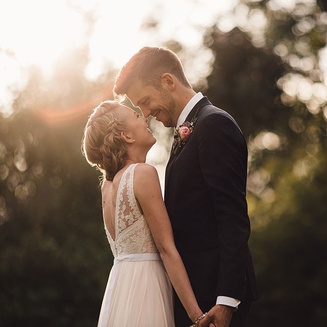 Bride in Catherine Deane Tamsin Wedding Dress & Groom in Paul Smith Suit