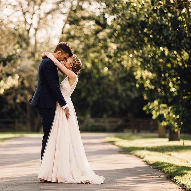Bride in Catherine Deane Tamsin Wedding Dress & Groom in Paul Smith Suit