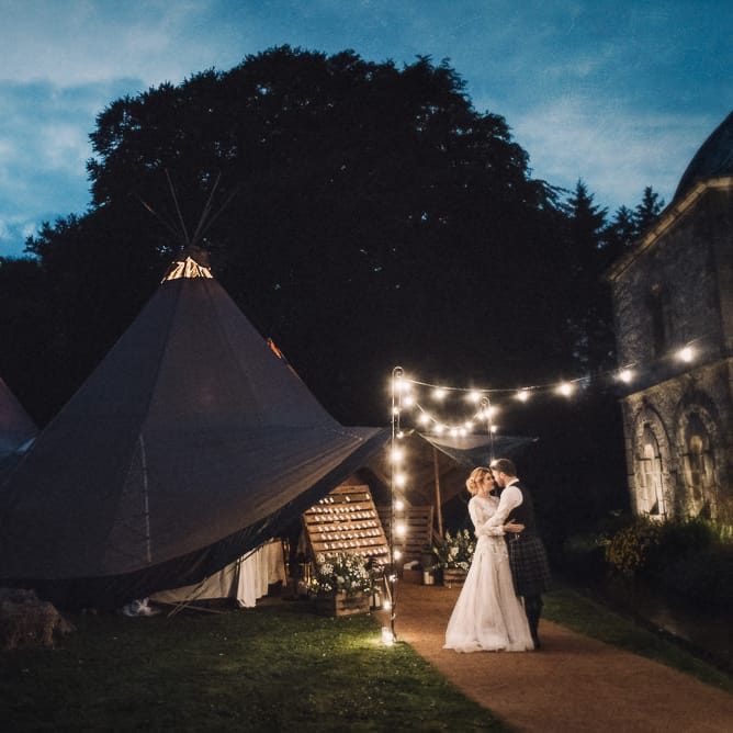 Festoon Lights For A Tipi Wedding // Rainy Tipi Wedding At The Coach House at Kinross House Scotland With Bride In Embellished Bespoke Dress And Images From Photos By Zoe
