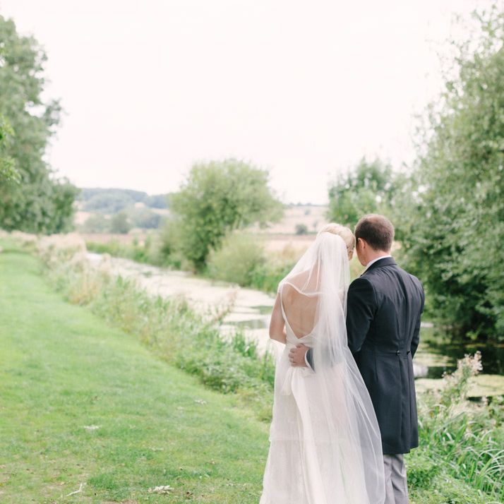 Bride in Charlie Brear Peyton Dress & Augustine Skirt & Groom in Traditional Morning Suit
