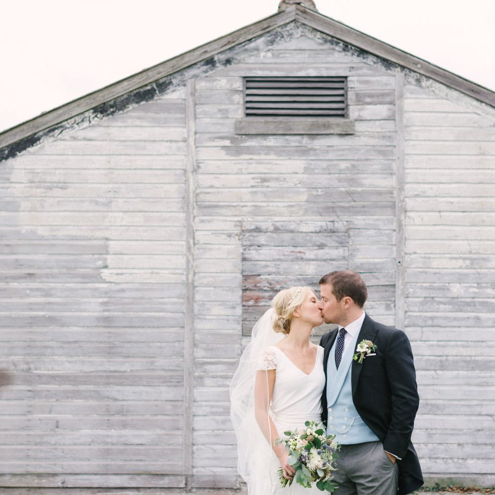 Bride in Charlie Brear Peyton Dress & Augustine Skirt & Groom in Traditional Morning Suit