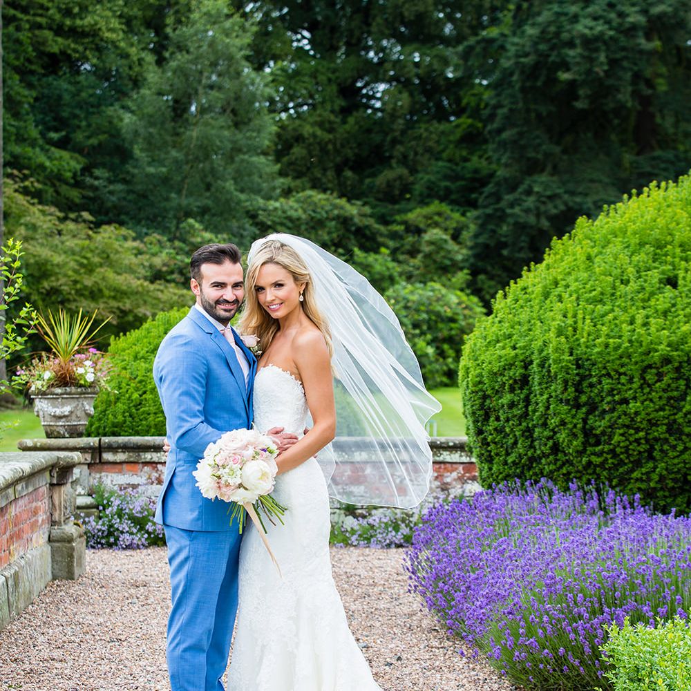 Bride in Pronovias Wedding Dress & Groom in Blue Hugo Boss Suit