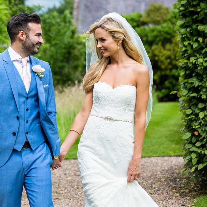 Bride in Pronovias Wedding Dress & Groom in Blue Hugo Boss Suit