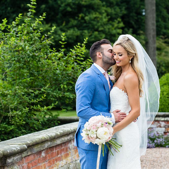 Bride in Pronovias Wedding Dress & Groom in Blue Hugo Boss Suit