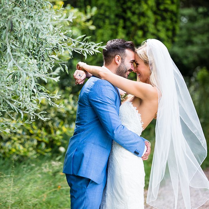 Bride in Pronovias Wedding Dress & Groom in Blue Hugo Boss Suit
