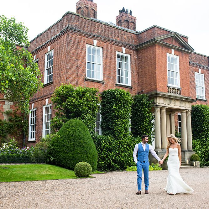 Bride in Pronovias Wedding Dress & Groom in Blue Hugo Boss Suit Outside Iscoyd Park in Shropshire