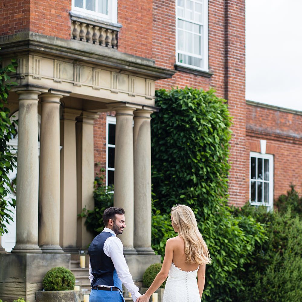 Bride in Pronovias Wedding Dress & Groom in Blue Hugo Boss Suit Outside Iscoyd Park in Shropshire