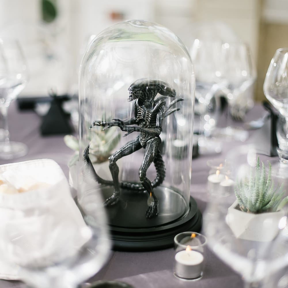 Iconic 80s Figure (Alien) in Bell Jar Table Centrepiece Wedding Decor | Monochrome Wedding at Syon Park London | Chris Barber Photography | Second Shooter Beatrici Photography