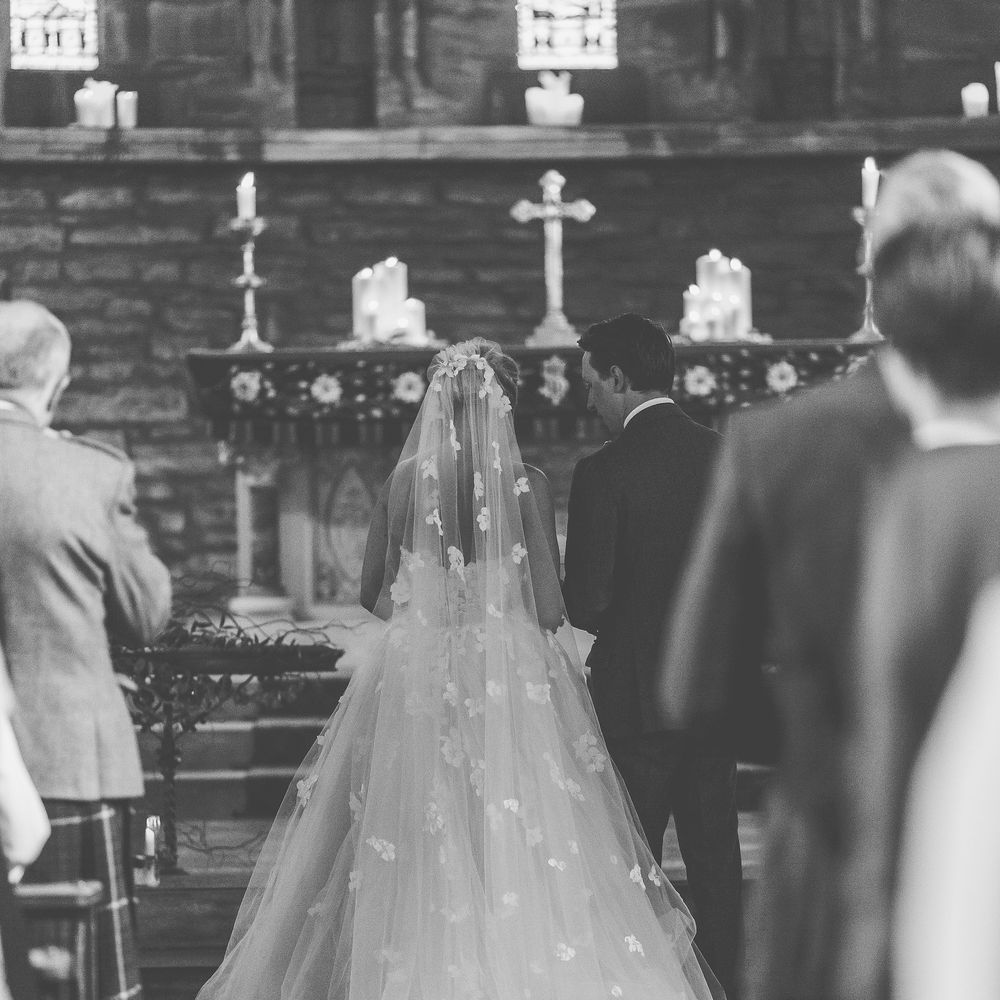 Bride in Bespoke Ian Stuart Gown with Detachable Tulle Skirt at the Altar