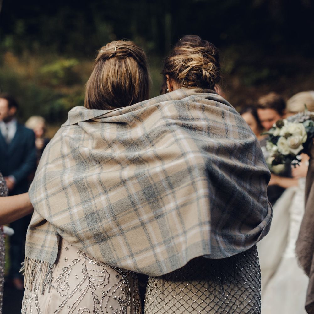 Bridesmaids Keep Warm Under Blanket