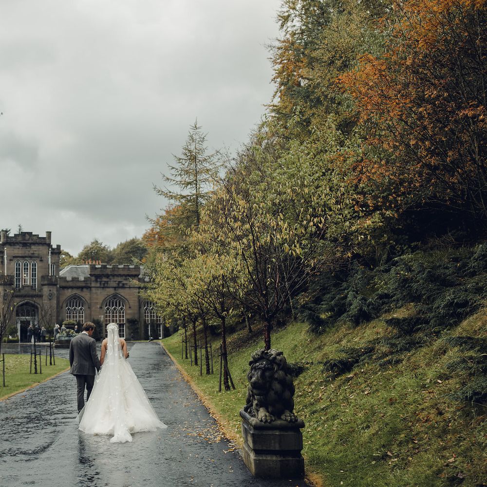 Bride in Bespoke Ian Stuart Gown with Detachable Tulle Skirt Outside Drumtochty Castle in Scotland