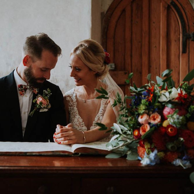 Church Wedding Ceremony | Bride in Lace & Tulle Gown | Groom in Black Suit & Liberty Print Bow Tie | Colourful DIY Barn Wedding at The Manor Barn, Cambridge | Meghan Lorna Photography