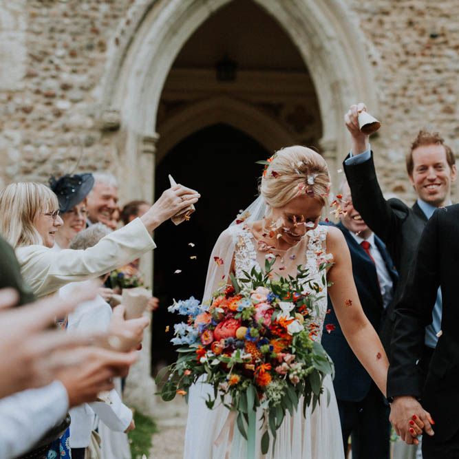 Confetti Exit | Bride in Lace & Tulle Gown | Groom in Black Suit & Liberty Print Bow Tie | Colourful DIY Barn Wedding at The Manor Barn, Cambridge | Meghan Lorna Photography