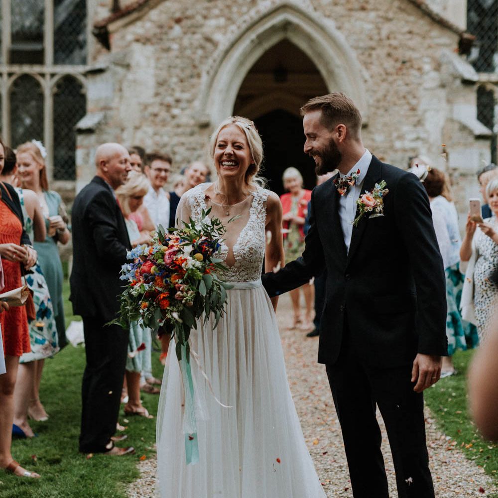 Confetti Exit | Bride in Lace & Tulle Gown | Groom in Black Suit & Liberty Print Bow Tie | Colourful DIY Barn Wedding at The Manor Barn, Cambridge | Meghan Lorna Photography