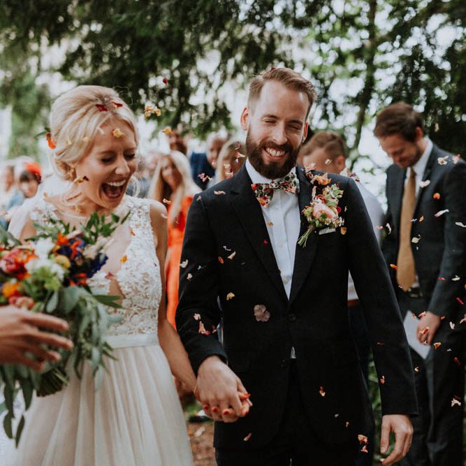 Confetti Exit | Bride in Lace & Tulle Gown | Groom in Black Suit & Liberty Print Bow Tie | Colourful DIY Barn Wedding at The Manor Barn, Cambridge | Meghan Lorna Photography