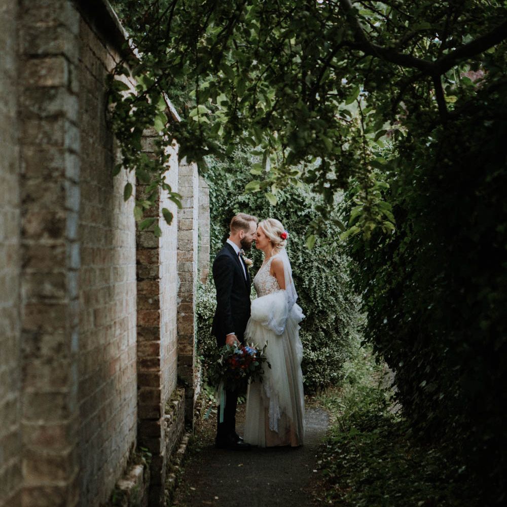 Bride in Lace & Tulle Gown | Groom in Black Suit & Liberty Print Bow Tie | Colourful DIY Barn Wedding at The Manor Barn, Cambridge | Meghan Lorna Photography