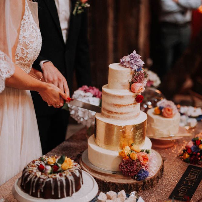 Bride & Groom Cutting the Cake | Colourful DIY Barn Wedding at The Manor Barn, Cambridge | Meghan Lorna Photography