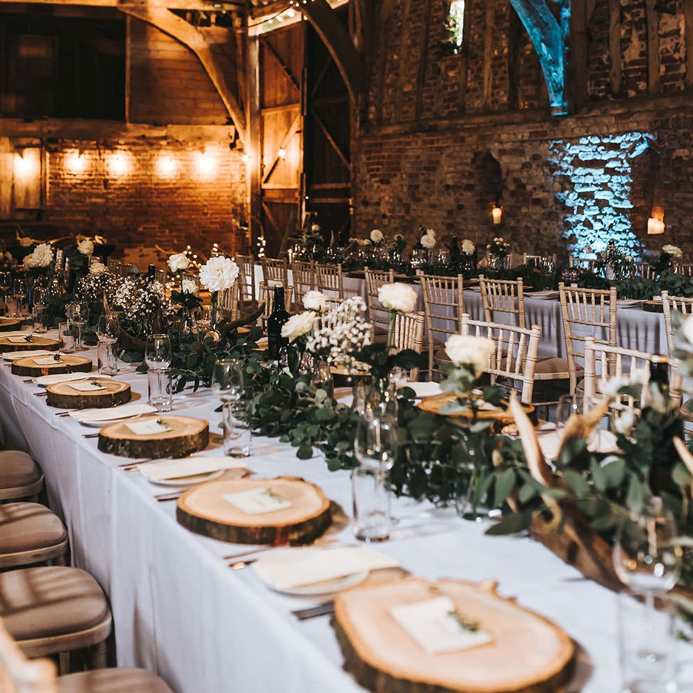Rustic Barn Reception with Wood Slices, Antlers, Fairy Lights & Greenery