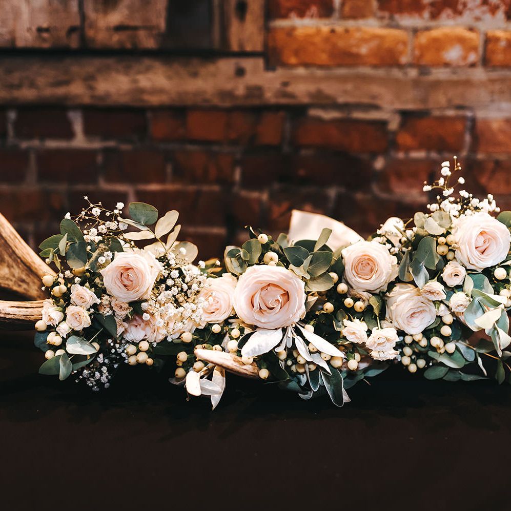 Antler Wedding Decor Adorned with Pink Roses