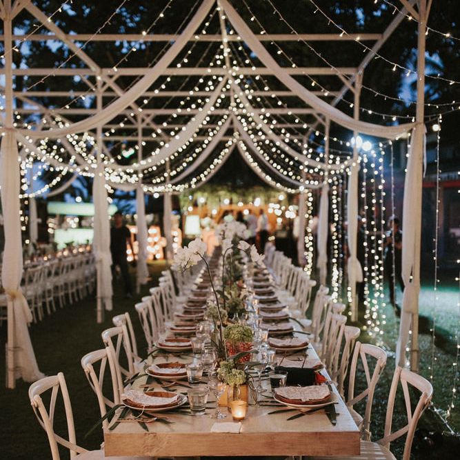 Incredible Outdoor Wedding Reception In Bali With Hanging Florals & Fairy Lights