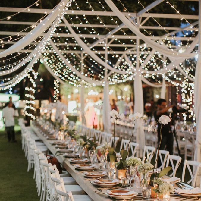 Incredible Outdoor Wedding Reception In Bali With Hanging Florals & Fairy Lights