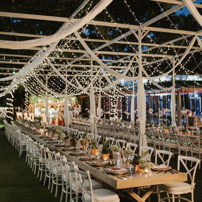 Incredible Outdoor Wedding Reception In Bali With Hanging Florals & Fairy Lights
