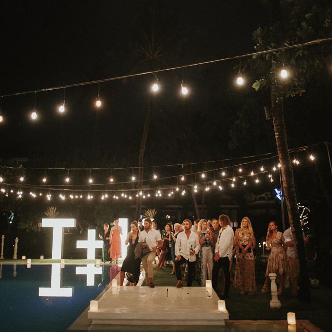 Incredible Outdoor Wedding Reception In Bali With Hanging Florals & Fairy Lights