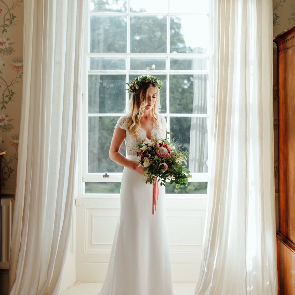 Bride in Bespoke Suzanne Neville Scarlett Bridal Gown | Protea Bouquet & Flower Crown | The Lou's Photography