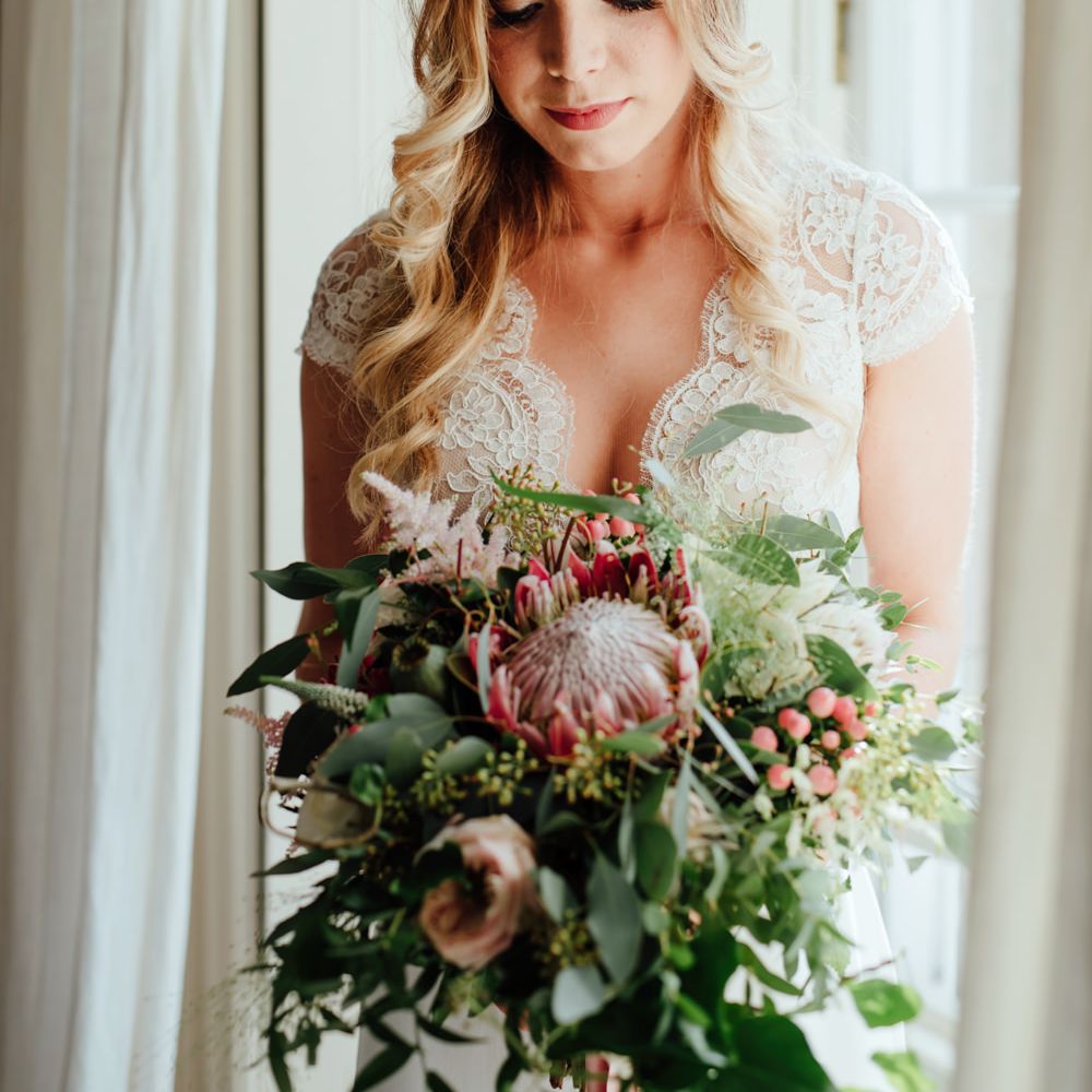 Bride in Bespoke Suzanne Neville Scarlett Bridal Gown | Protea Bouquet & Flower Crown | The Lou's Photography
