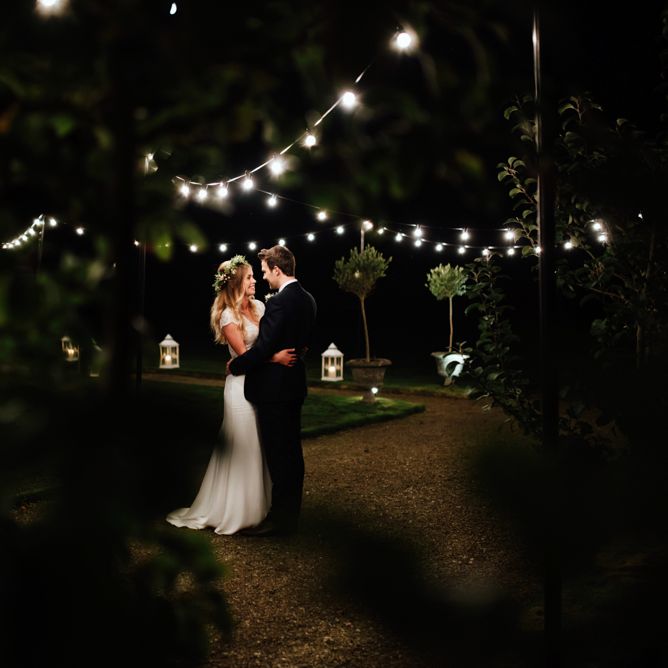 Festoon Lights | Bride in Bespoke Suzanne Neville Scarlett Bridal Gown | Groom in Herbie Frogg Suit & Liberty Print Mrs Bow Tie | The Lou's Photography