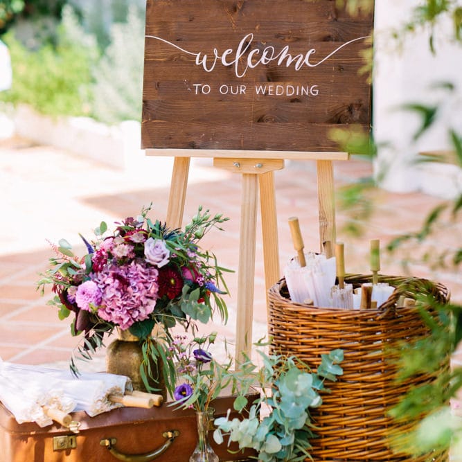 Wooden Wedding Welcome Sign with Vintage Suitcases & Parasols | Jewel Coloured Spanish Wedding Planned & Styled by Rachel Rose Weddings | Anna Gazda Photography