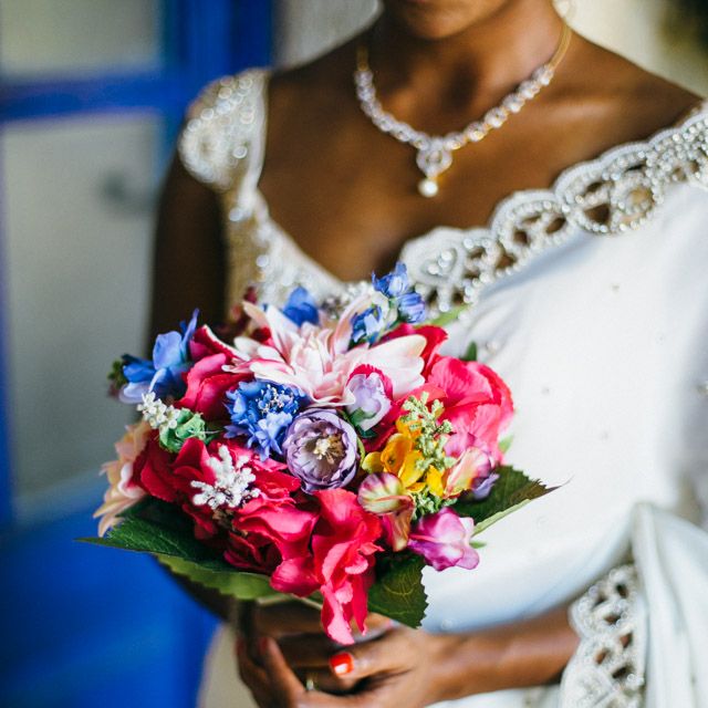 Bride In White & Gold Sari With Brightly Coloured Wedding Bouquet