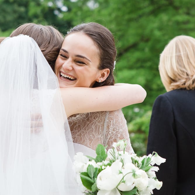 Wedding Guest Hugs | Bride in Ingrida Bridal Gown | Beautiful Classic Wedding at Cornwell Manor | Lucy Davenport Photography