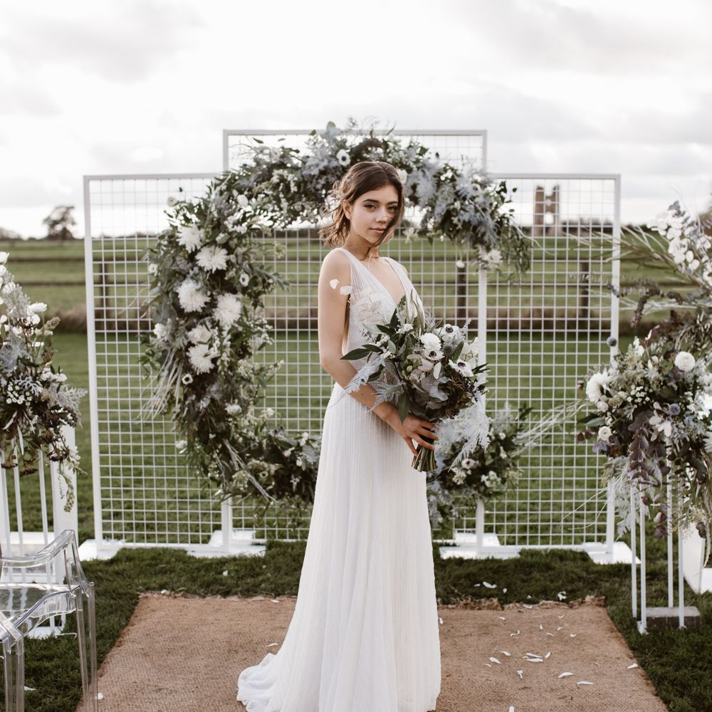 Bride in Watters Wtoo Bridal Gown | Aisle & Altar Style | Moon Gate Floral Arch by Swaffham Florist | Ghost Chairs | Nocturn Wedding Inspiration Planned & Styled by The Little Lending Company | Agnes Black Photography | Film by The Wilde Bride