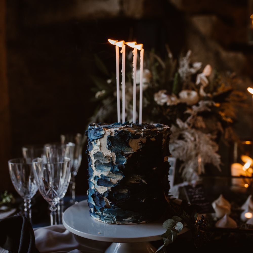 Inky Blue Buns of Fun Bakery Cake with Taper Candles | Nocturn Wedding Inspiration at Godwick Great Barn Planned & Styled by The Little Lending Company | Agnes Black Photography | Film by The Wilde Bride