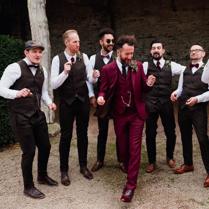 Groom in Burgundy Suit | Groomsmen in Bow Ties & Waistcoats | Outdoor Wedding at Dewsall Court Oxfordshire | Claudia Rose Carter Photography | Costa Sister Productions